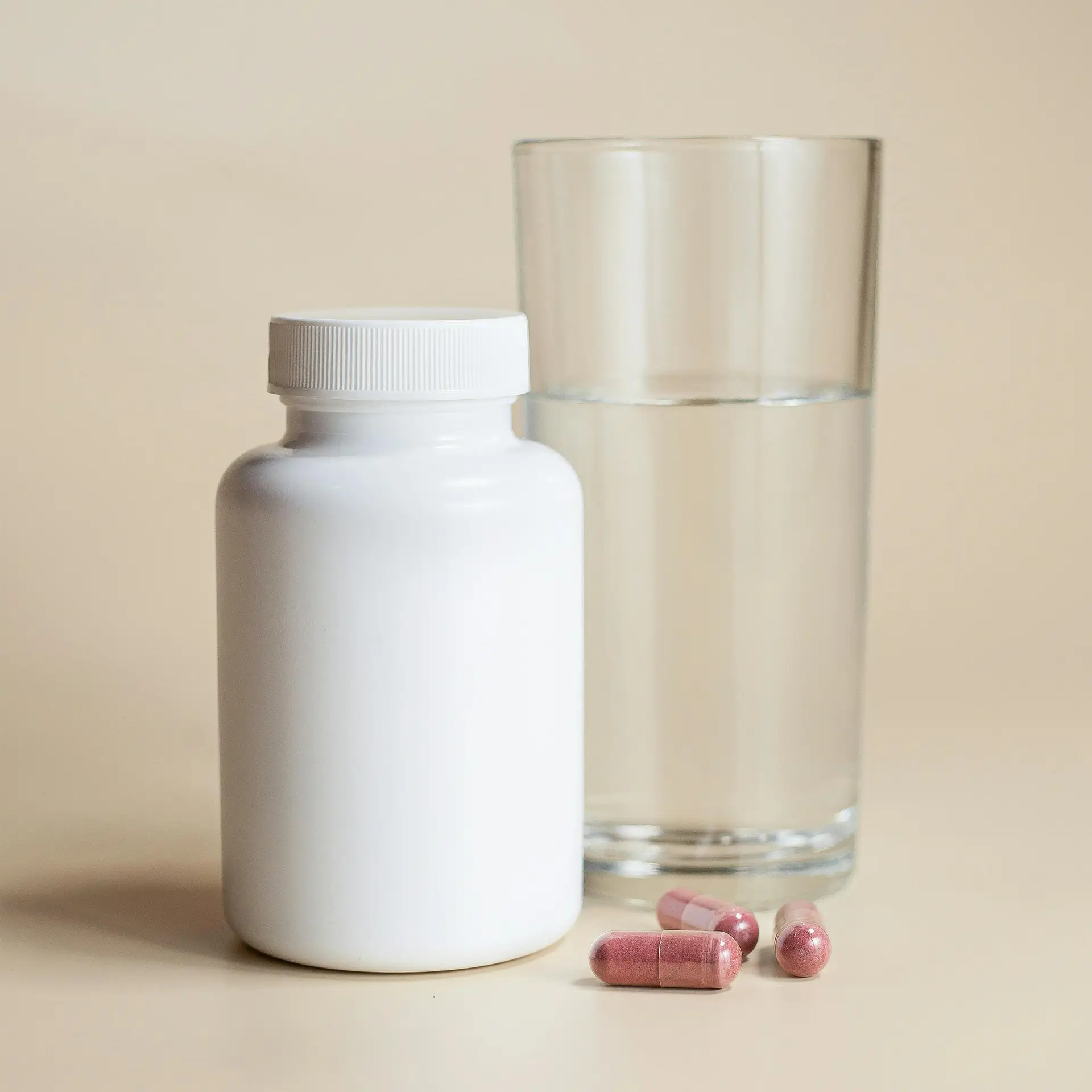supplements for tinnitus bottle with glass of water